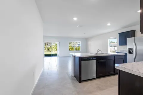 a kitchen with stainless steel appliances granite countertop a sink and a stove