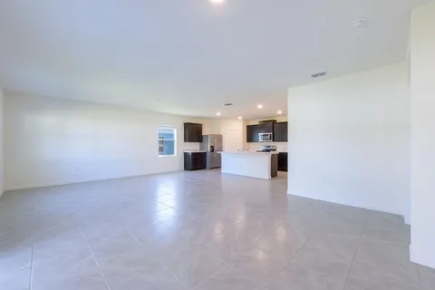 a view of a kitchen with a sink and a refrigerator