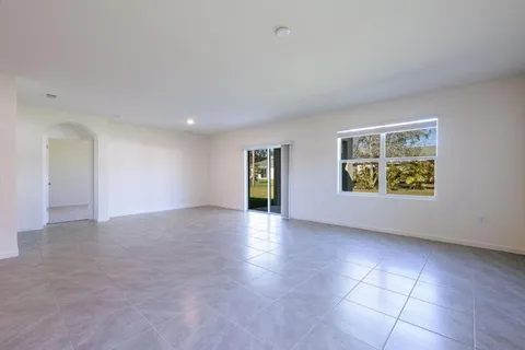 an empty room with windows and entrance