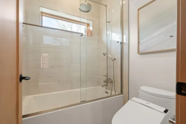 a spacious bedroom with a bed and a window