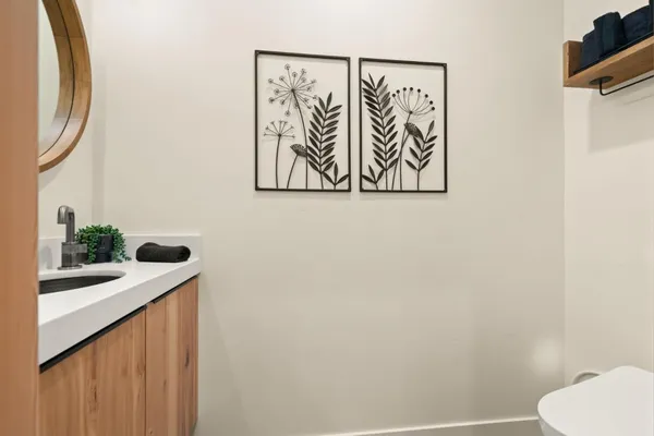a bathroom with a granite countertop sink and a mirror
