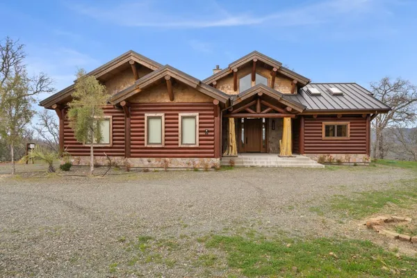 a view of a house with a yard and garage