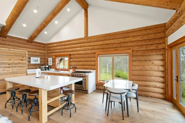 an aerial view of a wooden house with outdoor space and mountain view