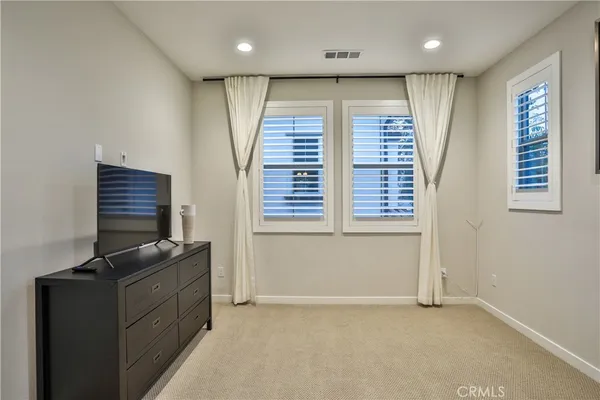 a living room with furniture and flat screen tv