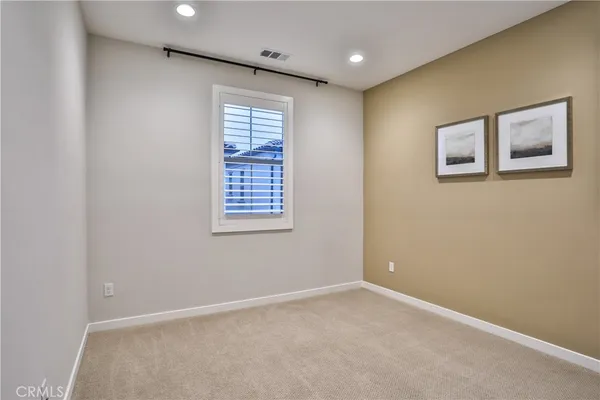 a view of an empty room with closet area