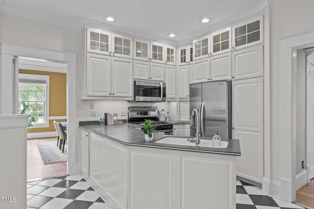 a spacious bathroom with a granite countertop sink a mirror and shower