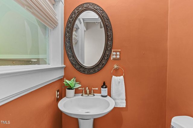 a living room with wooden floor and a fireplace