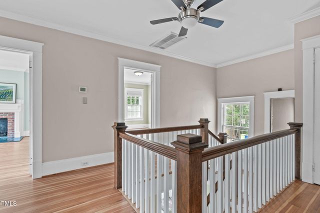 a bed sitting in a spacious bedroom and a fireplace