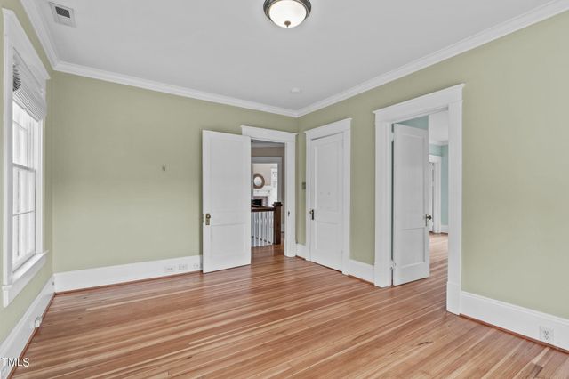 a bedroom with a bed couch and a large window