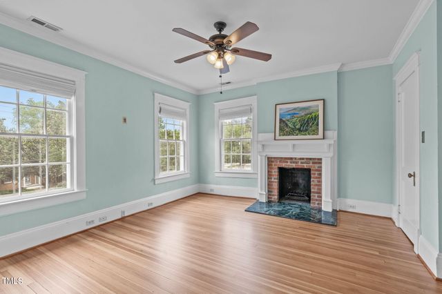 a spacious bedroom with a bed and a fireplace