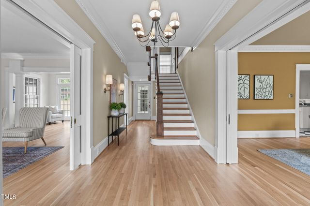 a view of living room with furniture and wooden floor
