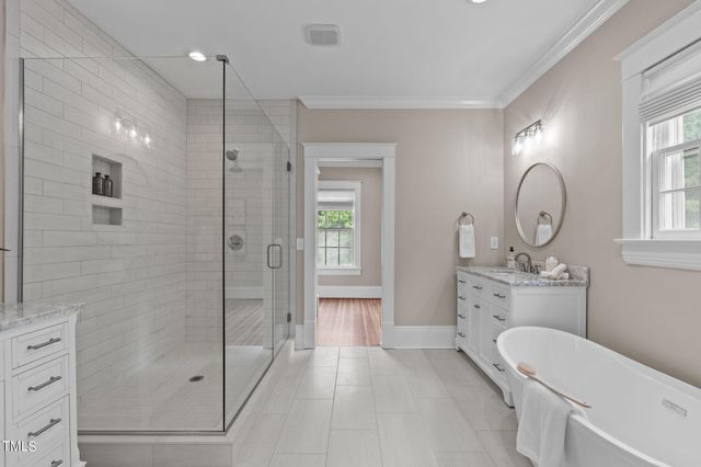 a view of a house with a yard and potted plants