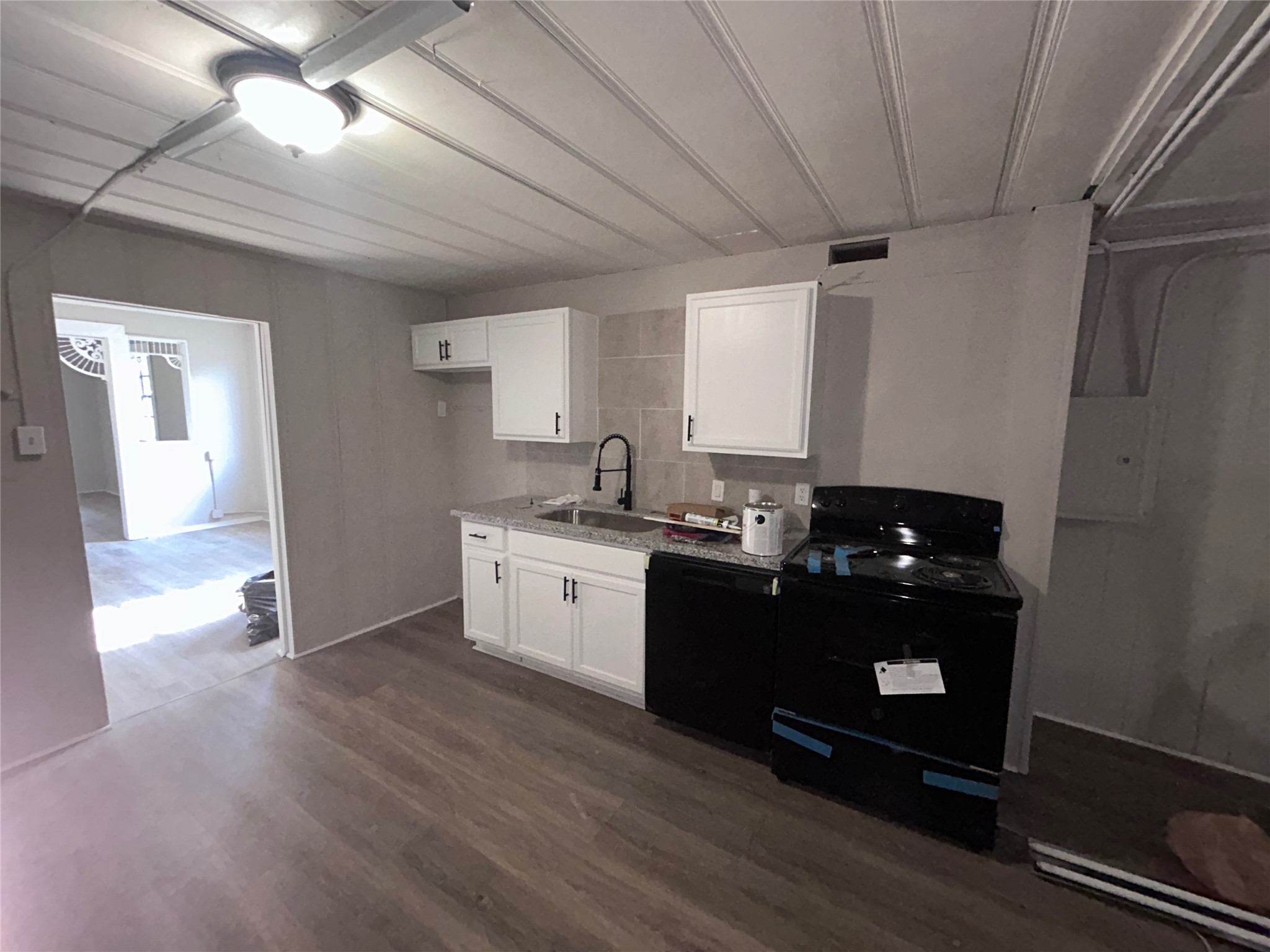 a kitchen with sink and cabinets