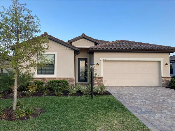 a front view of a house with a yard and garage