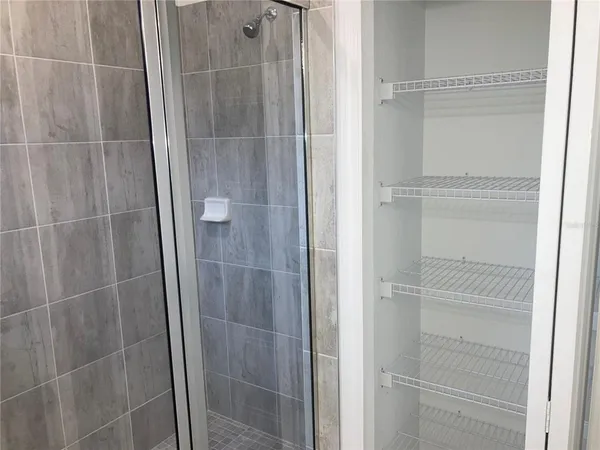 a bathroom with a glass shower door