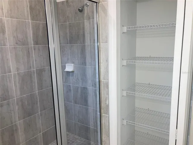 a bathroom with a glass shower door