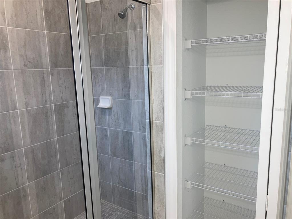 6511 Clairborne Lane Bradenton, FL 34211 - Photo 8 of 12 a bathroom with a glass shower door