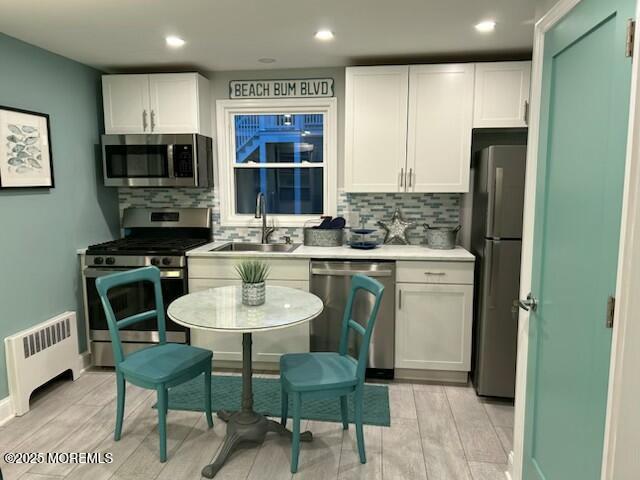 65 Mt Hermon Way, Unit 4 Ocean Grove, NJ 07756 - Photo 3 of 10 a kitchen with a table chairs refrigerator and microwave