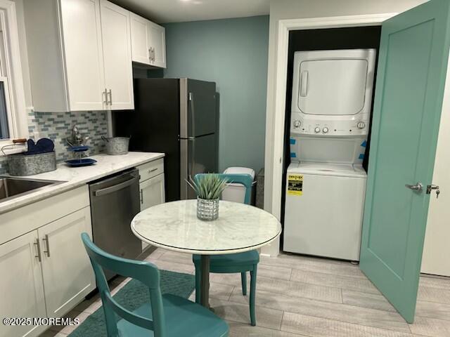 65 Mt Hermon Way, Unit 4 Ocean Grove, NJ 07756 - Photo 5 of 10 a kitchen with stainless steel appliances a refrigerator a sink a table and chairs
