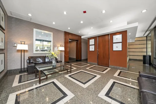 a living room with hard wood flooring and furniture