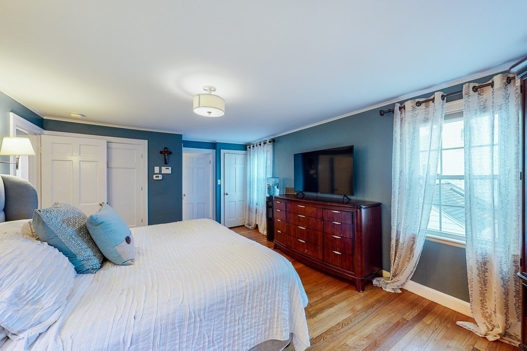 14 Gordon Road Milton, MA 02186 - Photo 21 of 38 a bedroom with a bed and a flat screen tv