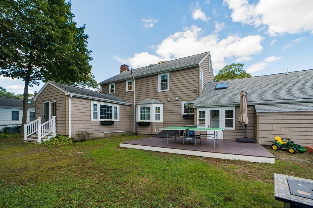 14 Gordon Road Milton, MA 02186 - Photo 36 of 38 a backyard of a house with table and chairs