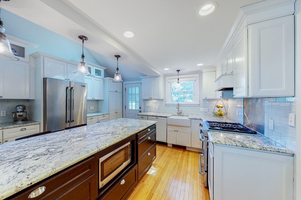 14 Gordon Road Milton, MA 02186 - Photo 4 of 38 a kitchen with granite countertop a sink a counter space stainless steel appliances and cabinets