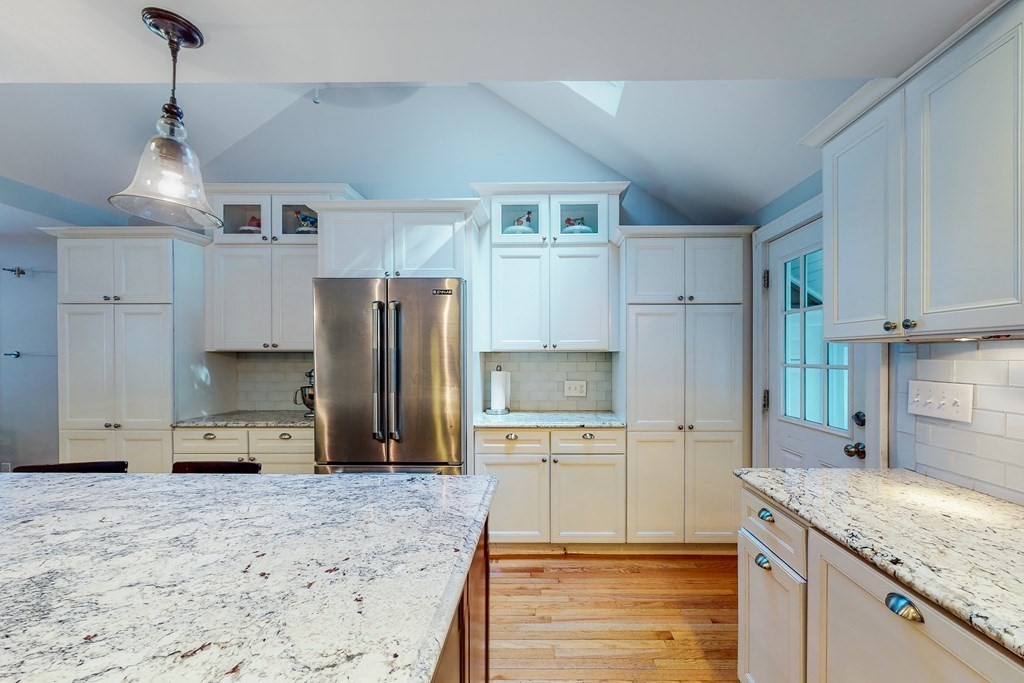 14 Gordon Road Milton, MA 02186 - Photo 7 of 38 a kitchen with kitchen island granite countertop a stove a sink a refrigerator and white cabinets with wooden floor