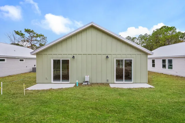 a view of a house with swimming pool and sitting area