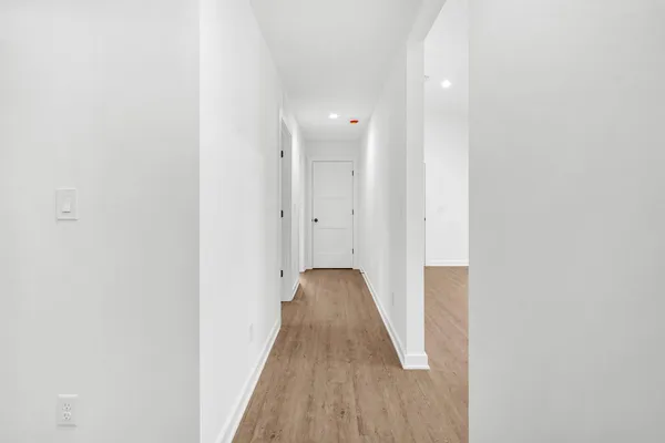 a view of a room with wooden floor