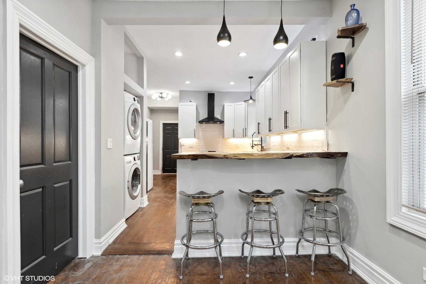 456 West 44th Street, Unit 1 Chicago, IL 60609 - Photo 8 of 19 a kitchen with stainless steel appliances kitchen island granite countertop a refrigerator and a stove top oven