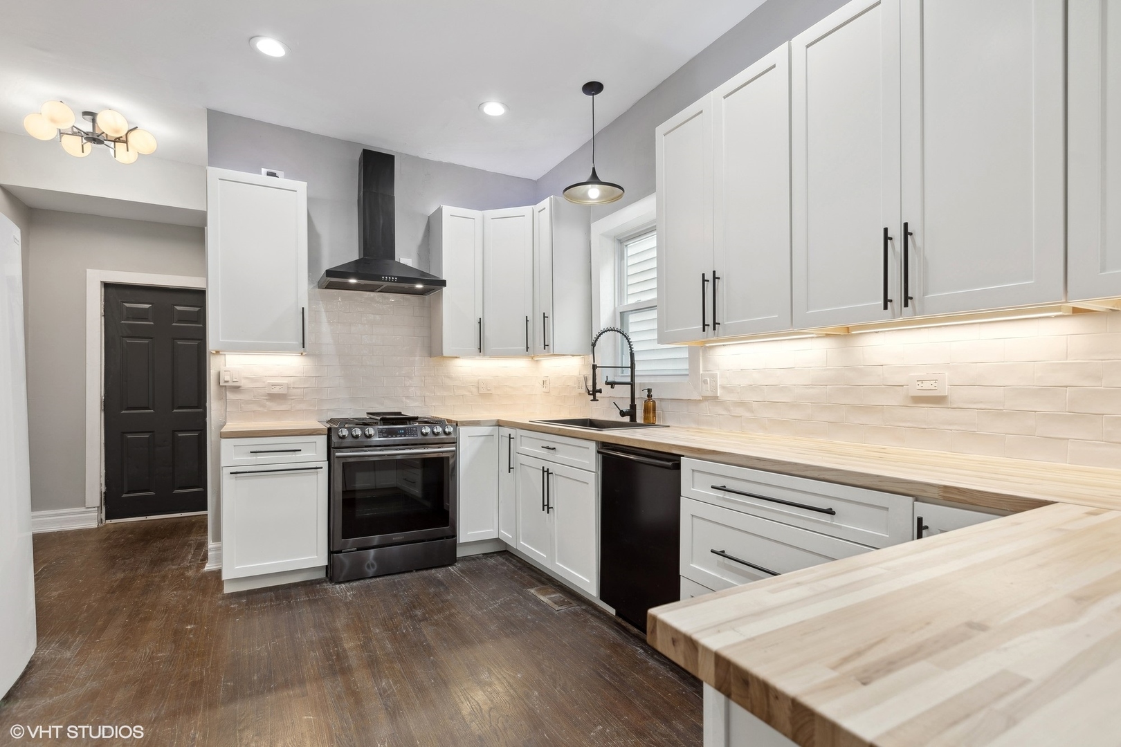 456 West 44th Street, Unit 1 Chicago, IL 60609 - Photo 10 of 19 a kitchen with stainless steel appliances granite countertop a sink stove and refrigerator