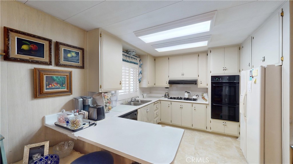 14851 Jeffrey Road, Unit 117 Irvine, CA 92618 - Photo 19 of 45 a kitchen with stainless steel appliances granite countertop a refrigerator and a stove top oven