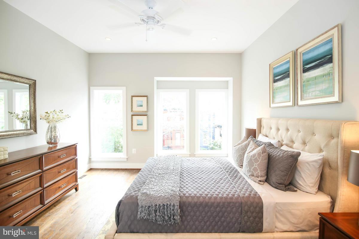 423 7th Street Southeast Washington, DC 20003 - Photo 19 of 29 a bedroom with a large bed and a dresser