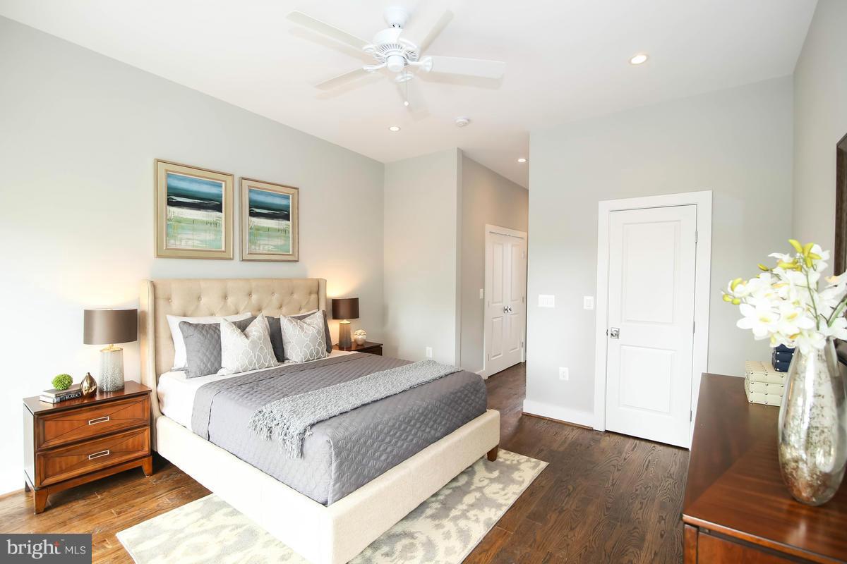 423 7th Street Southeast Washington, DC 20003 - Photo 21 of 29 a bedroom with a bed potted plant with the wooden floor