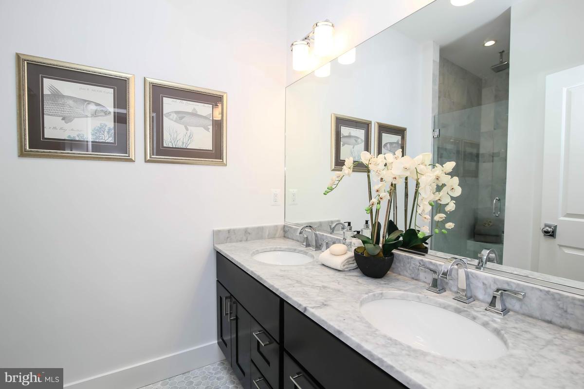 423 7th Street Southeast Washington, DC 20003 - Photo 23 of 29 a bathroom with a double vanity sink and a mirror