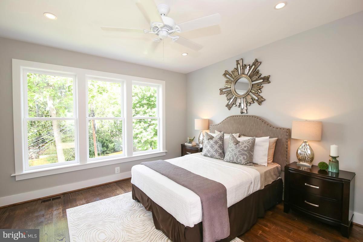 423 7th Street Southeast Washington, DC 20003 - Photo 26 of 29 a bedroom with a bed and a chandelier