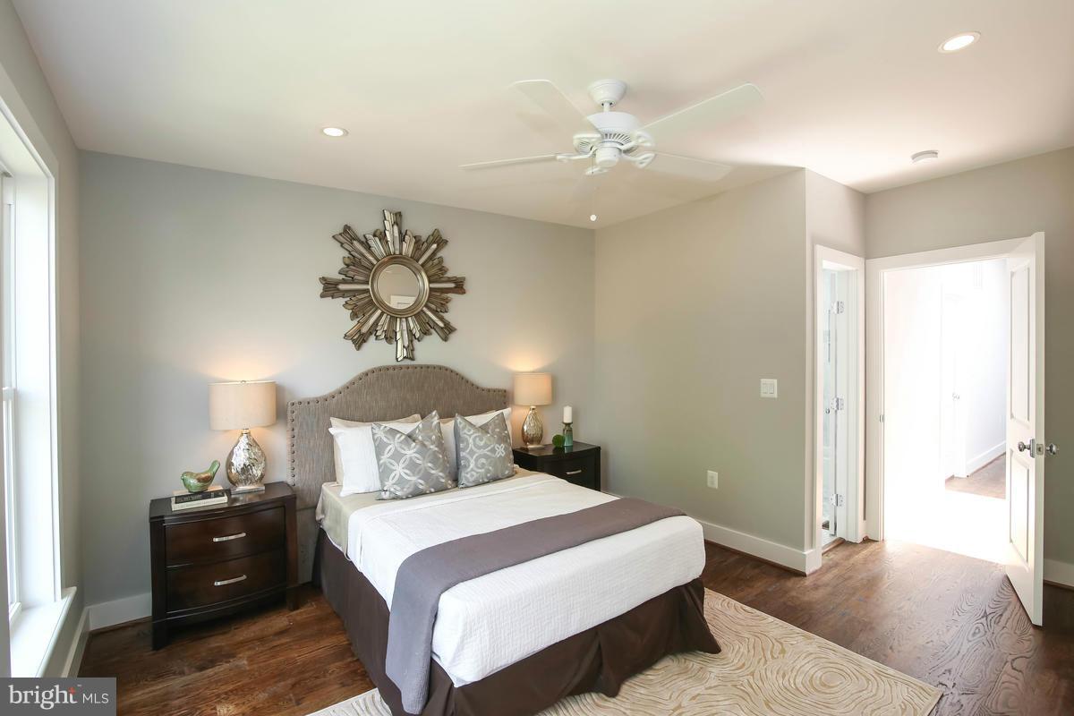 423 7th Street Southeast Washington, DC 20003 - Photo 27 of 29 a bedroom with a bed and a chandelier