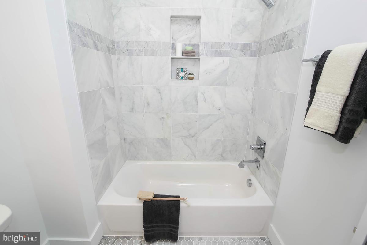 423 7th Street Southeast Washington, DC 20003 - Photo 7 of 29 a bathroom with a bathtub and a shower