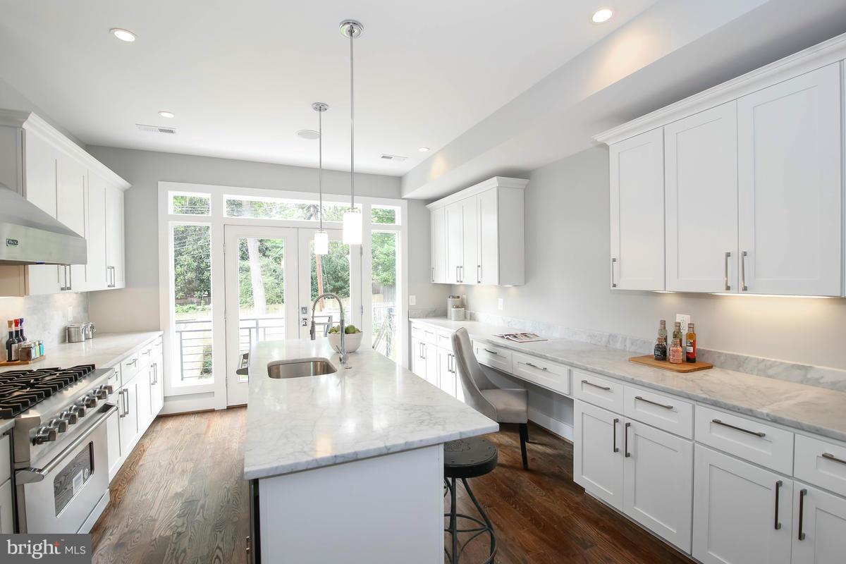 423 7th Street Southeast Washington, DC 20003 - Photo 8 of 29 a kitchen with sink stove and cabinets