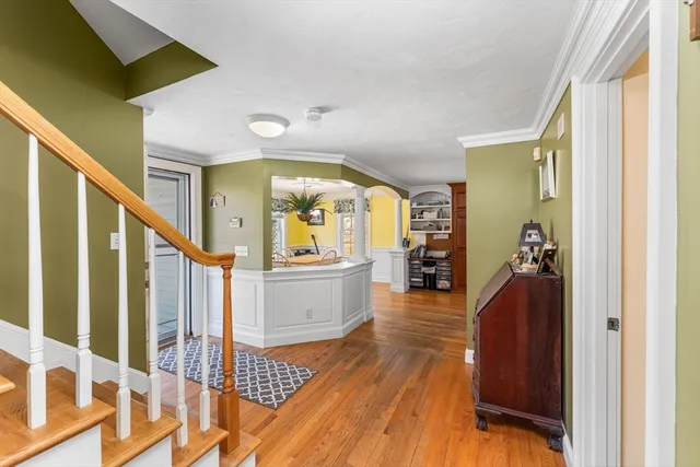 a view of a hallway view with wooden floor and staircase