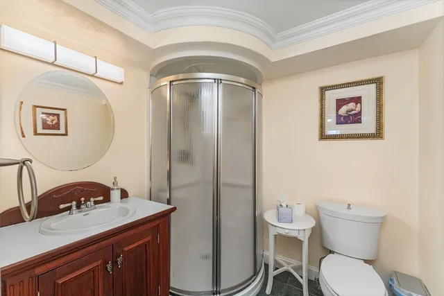 a bathroom with a toilet a sink and mirror