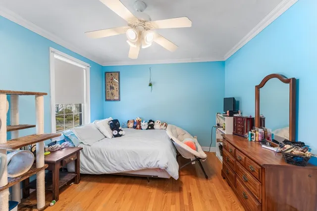 a bedroom with furniture and a wooden floor