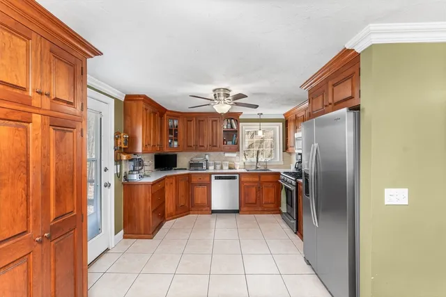 a kitchen with stainless steel appliances granite countertop a refrigerator and a sink