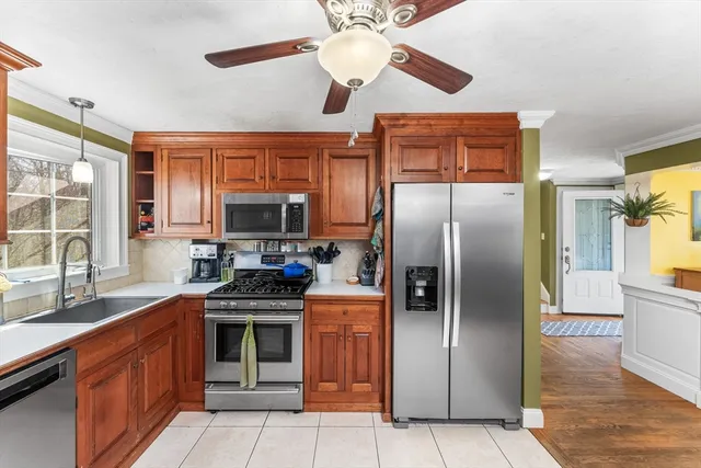 a kitchen with stainless steel appliances granite countertop a refrigerator and a sink