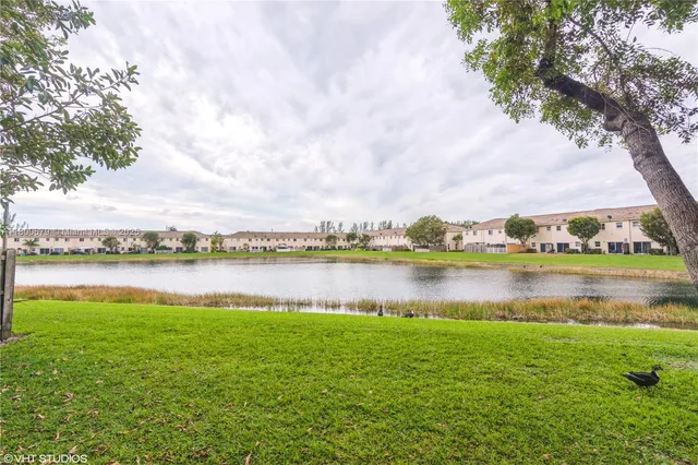 a view of a lake with houses in the back