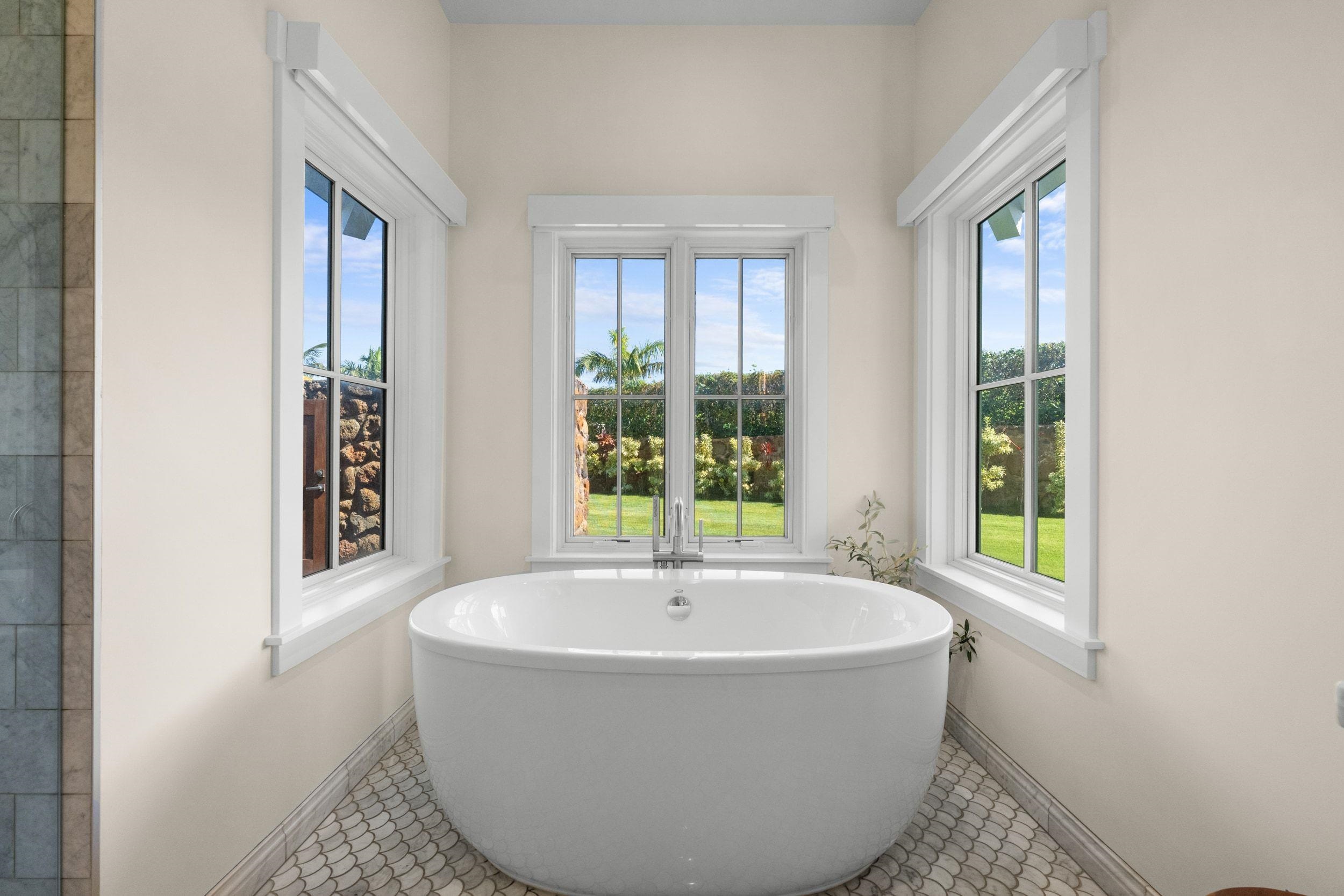 300 Mahana Ridge Street Lahaina, HI 96761 - Photo 28 of 50 a white bath tub sitting in a bathroom next to a window
