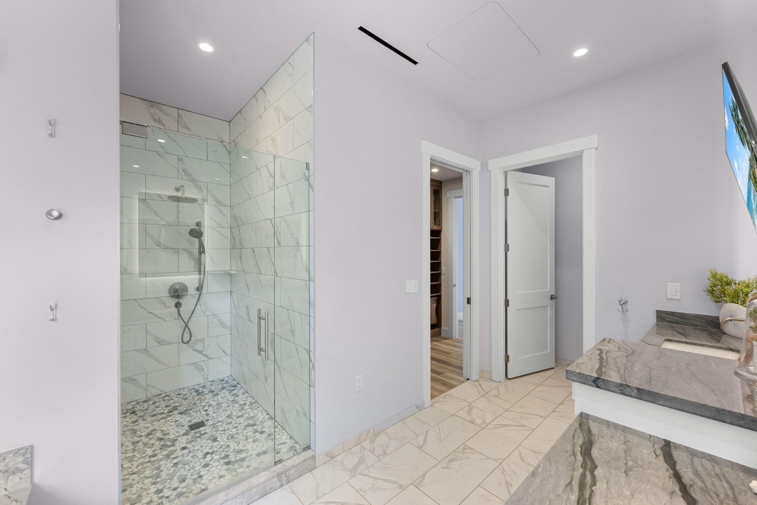 300 Mahana Ridge Street Lahaina, HI 96761 - Photo 37 of 50 a bathroom with a granite countertop sink a shower and a mirror