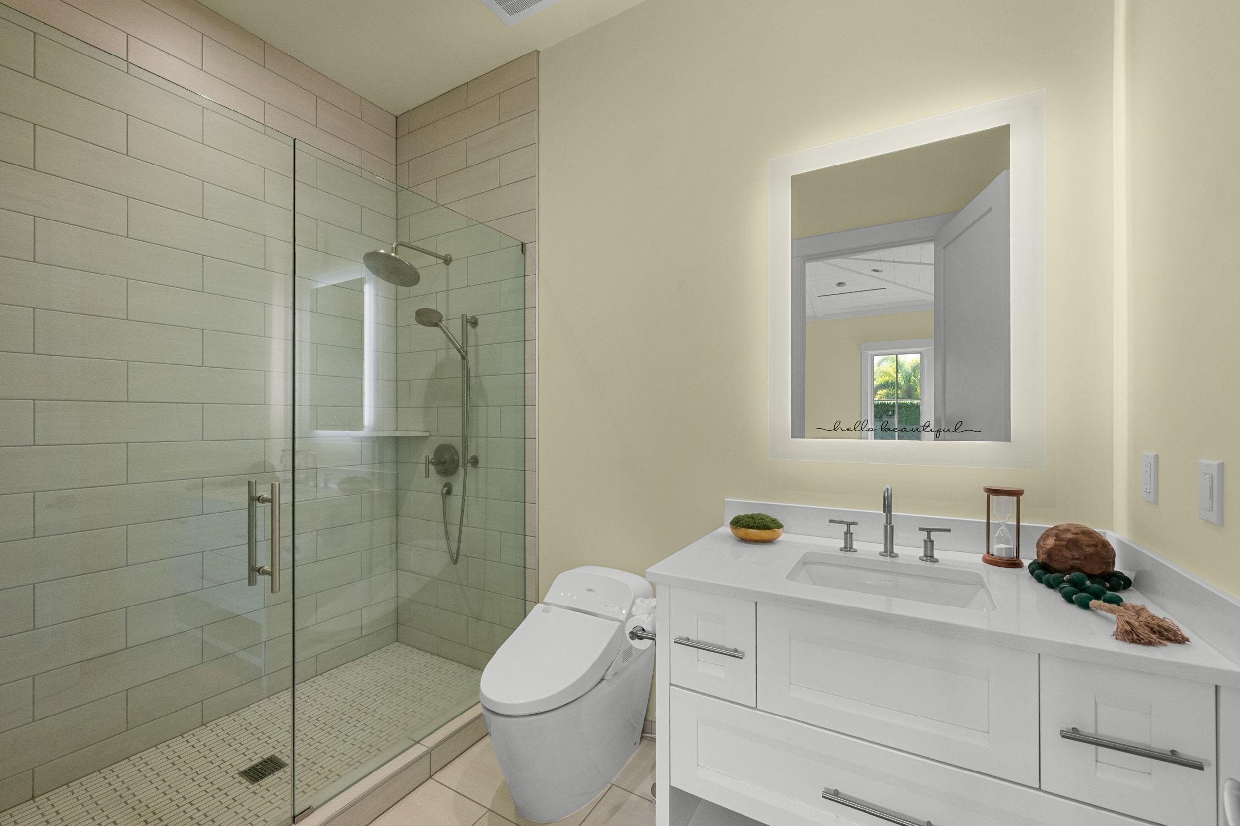 300 Mahana Ridge Street Lahaina, HI 96761 - Photo 41 of 50 a bathroom with a toilet a sink a glass door a shower and a mirror