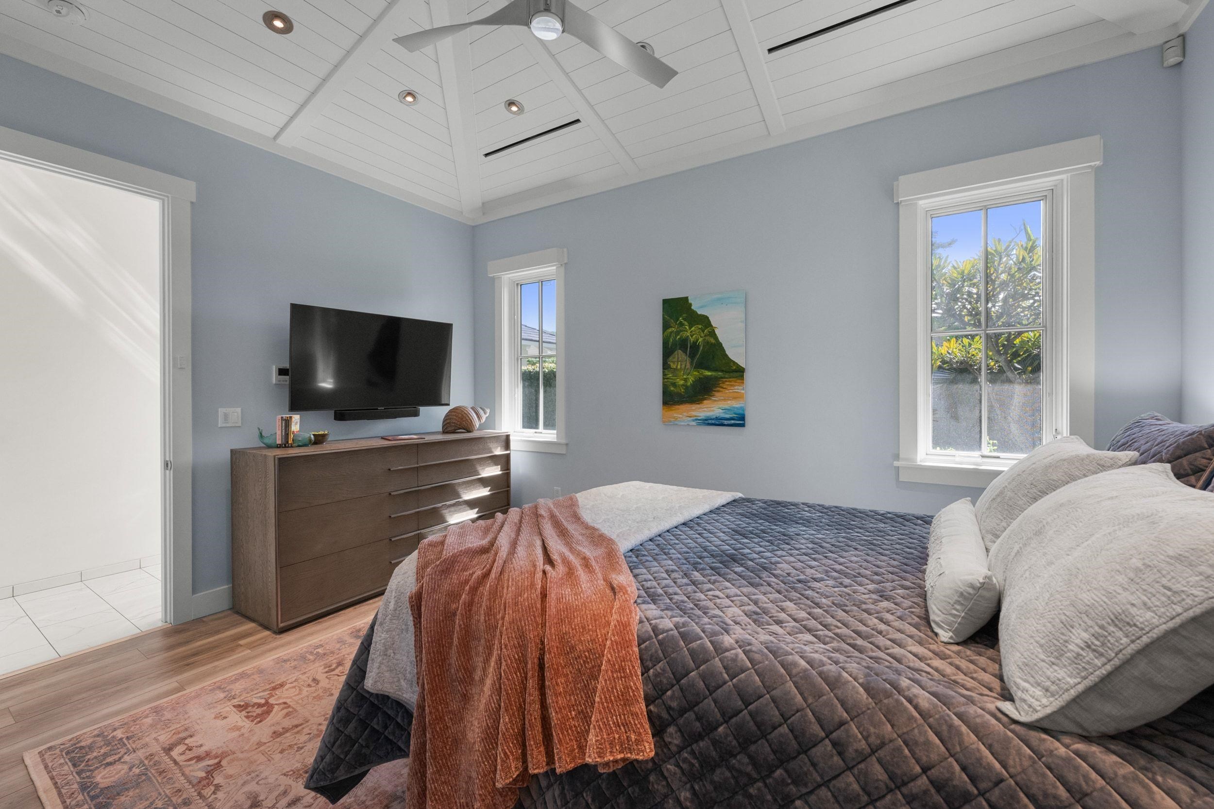 300 Mahana Ridge Street Lahaina, HI 96761 - Photo 44 of 50 a bedroom with a bed and a flat tv screen on dresser